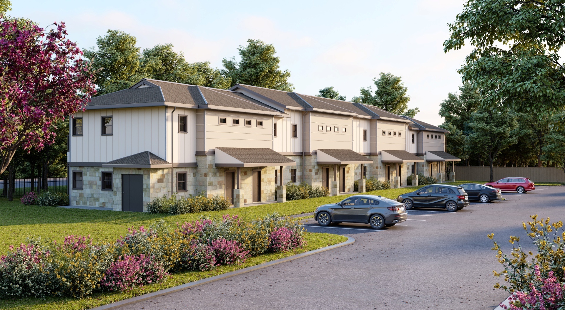 A row of houses with cars parked in front.